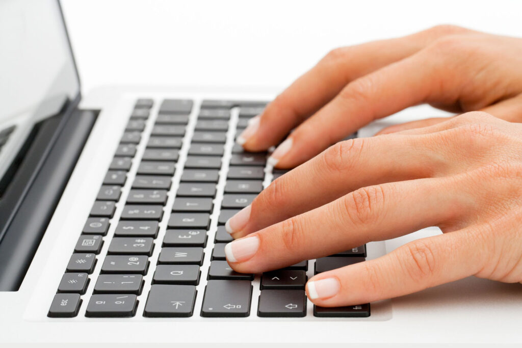 picture of hands working on a laptop