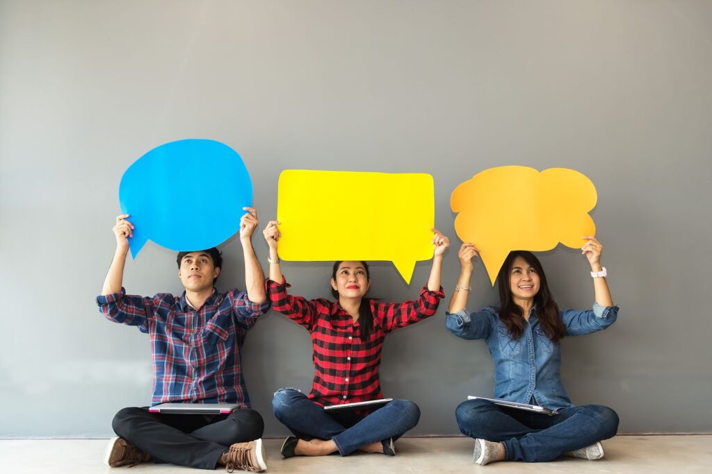 on the picture we can see 3 people everyone hold chat icons