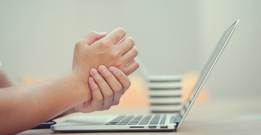 picture of hands tired because of work on keyboard