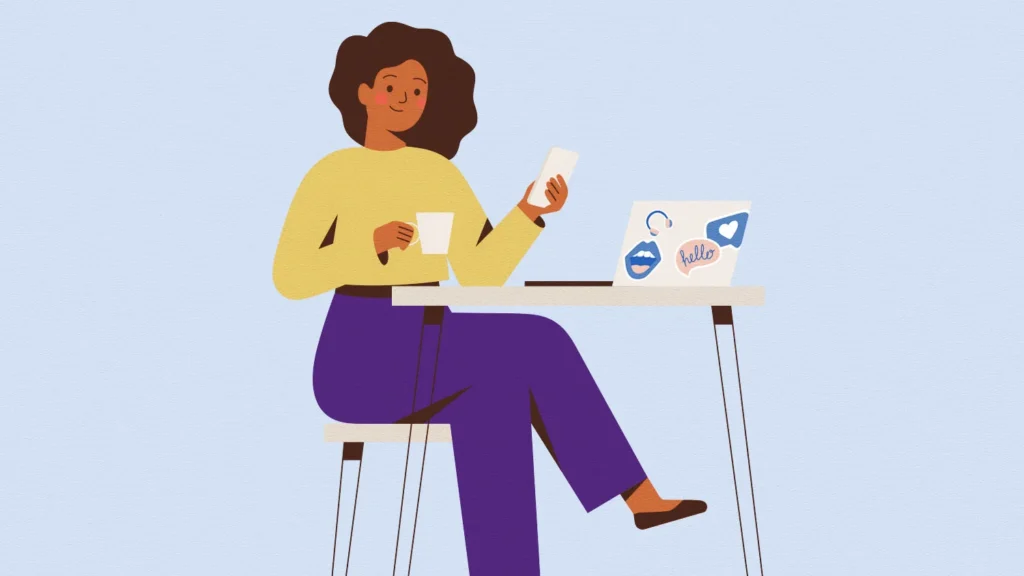 picture of woman sitting on a table with laptop, she's drinking coffe and eating lunch