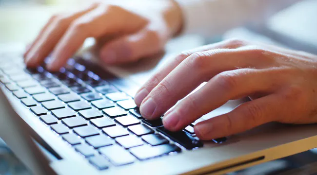 picture of hands working on a keyboard
